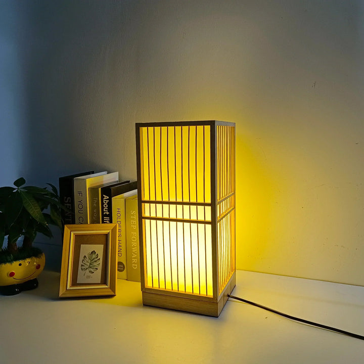 Minimalist Zen decor table lamp featuring a natural wood base & delicate rice paper shade for soft glow.