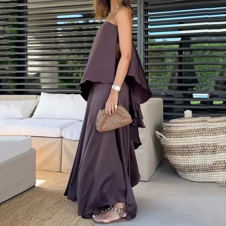 Elegant Jolina purple off-shoulder blouse and maxi skirt two-piece set for women. Ideal casual summer vacation wear.