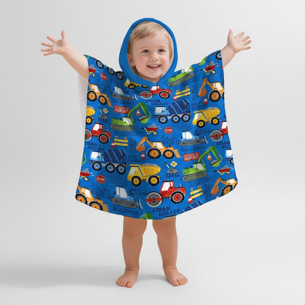 Close-up of kids' construction print hooded poncho, showcasing the detailed vehicle design and soft fabric