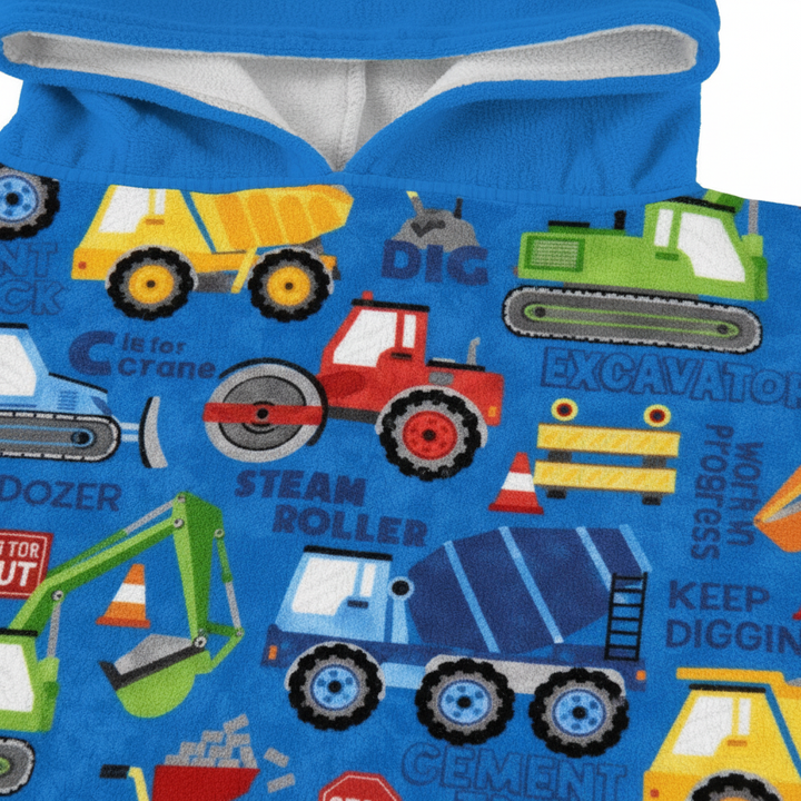 Close-up of kids' construction print hooded poncho fabric, showcasing water-repellent polyester material.