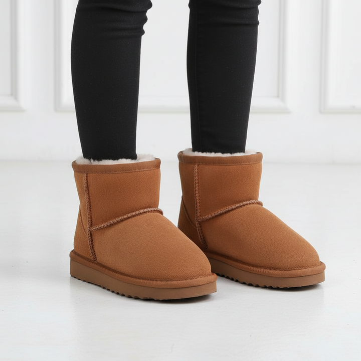Side view of youth waterproof warm winter boots, high-top design for ankle support in snow