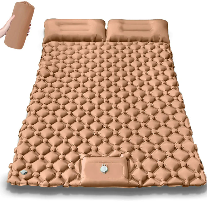 Person inflating Kieran Double Camping Mattress with foot pump, convenient outdoor gear