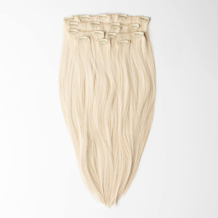 Light Ash Blonde clip-in human hair extensions for women, adding natural volume & length.