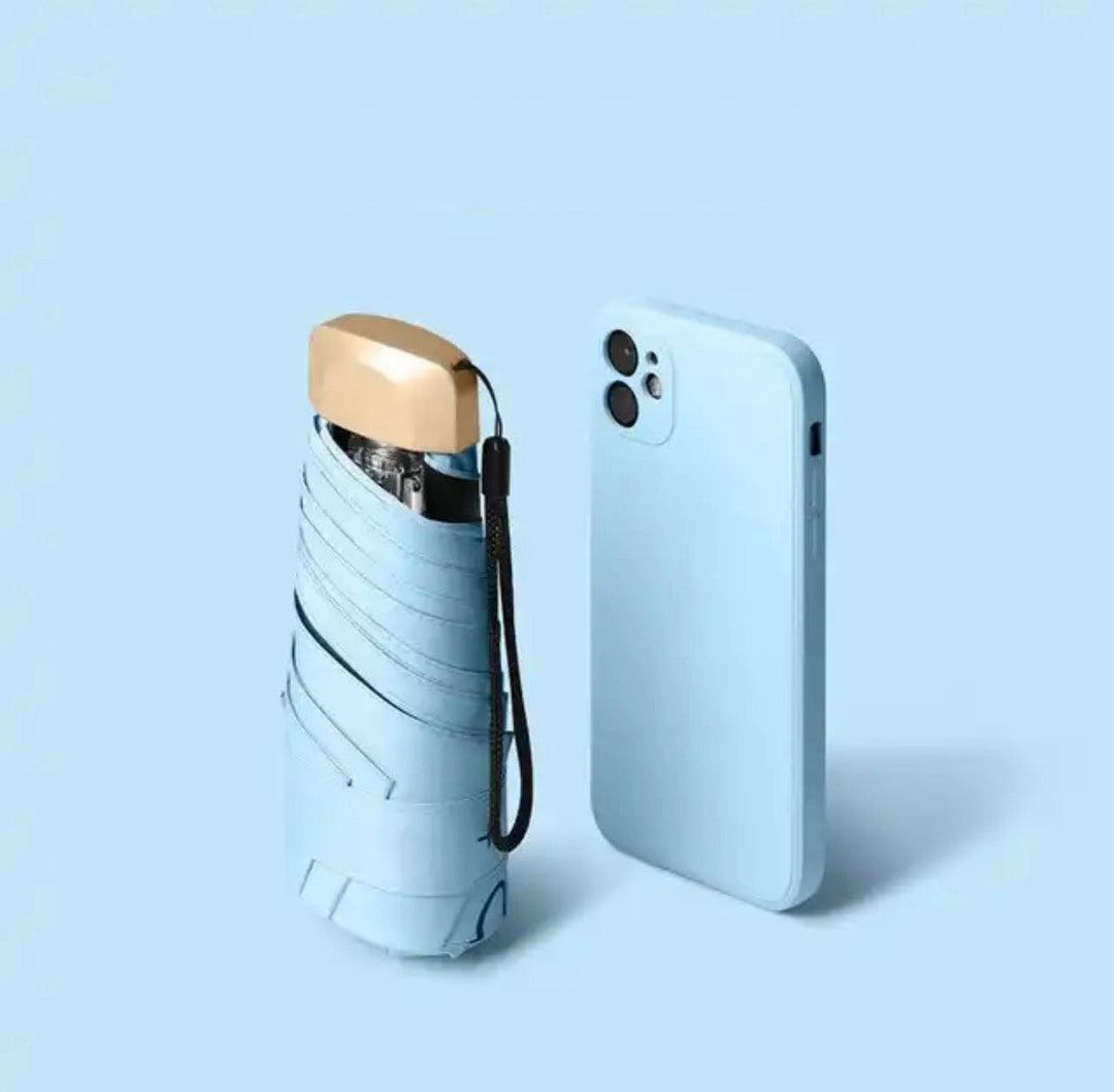 Light blue ultra-compact foldable mini travel umbrella, unisex rain & sun protection.