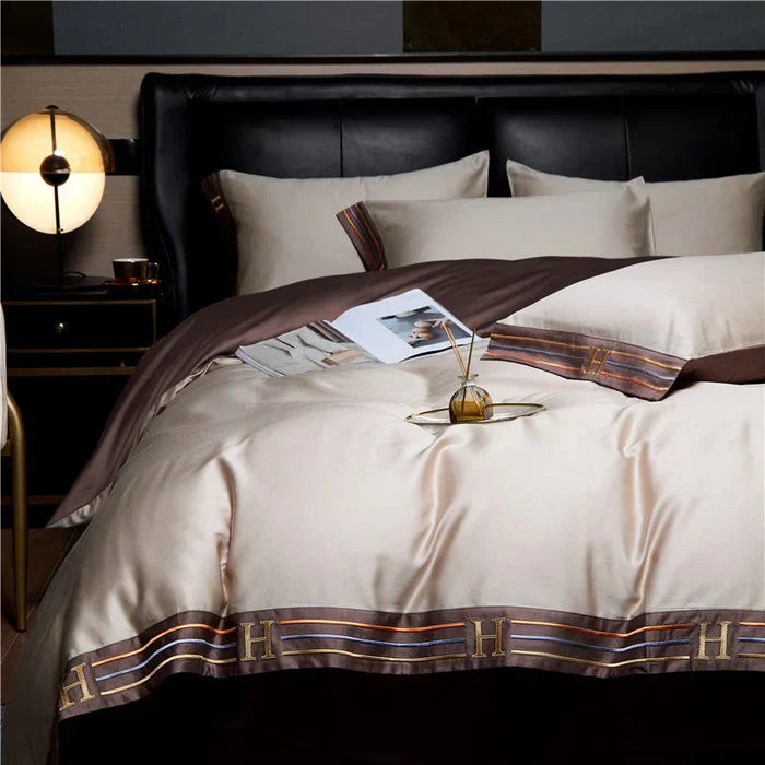 Full view of a bed adorned with luxurious embroidered satin cotton bedding.