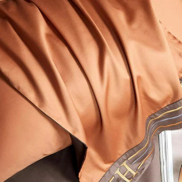 Luxurious satin bedding fabric, beautifully draped. Highlights soft, smooth texture for an opulent bedroom look.