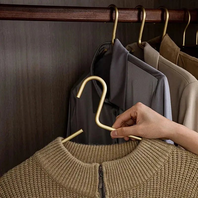 Elegant gold anti-slip metal hangers for luxury wardrobe organization. Premium suit & coat care solution.
