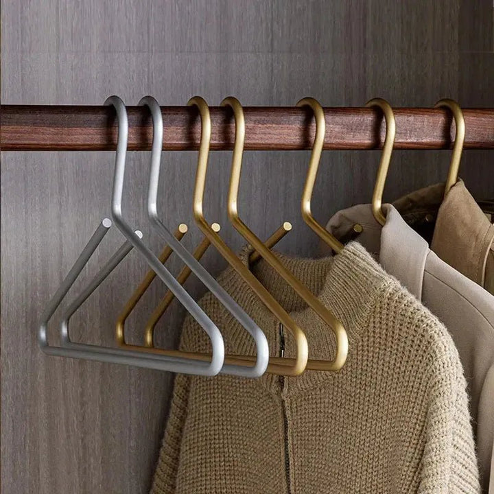 Set of luxury gold anti-slip metal hangers, enhancing wardrobe organization. Ideal for various garments.