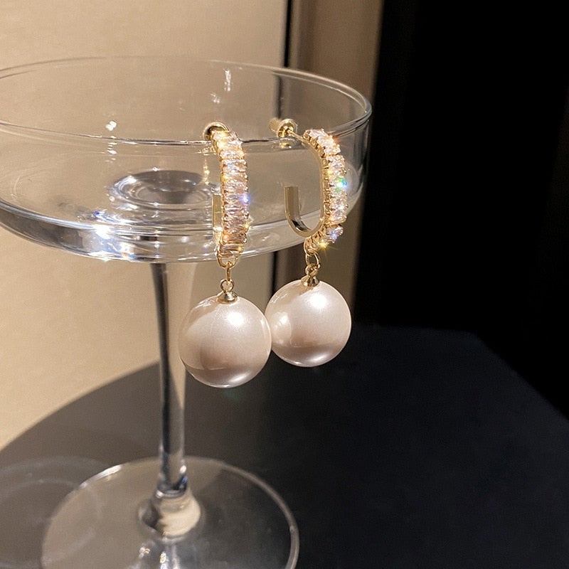 Elegant women's pearl & zirconia dangle earrings, a classic luxury jewelry piece for sophisticated style.