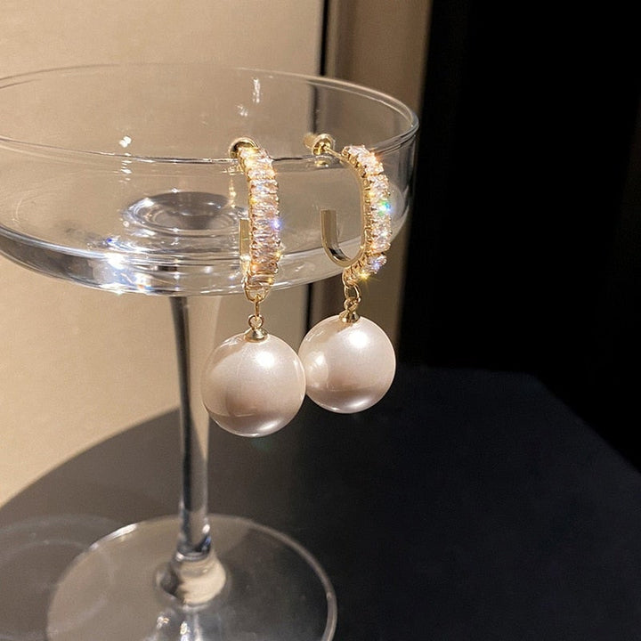 Glamorous women's luxury drop earrings with pearls & sparkling zirconia. Fashionable statement jewelry for her.