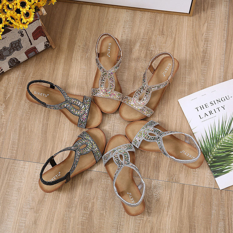 Elegant women's platform sandals with a stylish wedge and dazzling rhinestone details.
