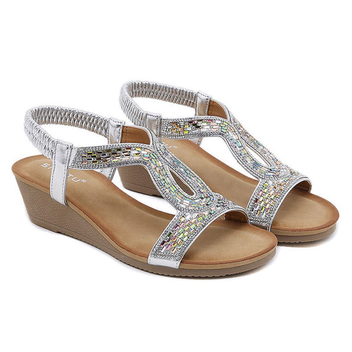 Pretty women's wedge sandals with an array of sparkling rhinestones for a radiant glow.