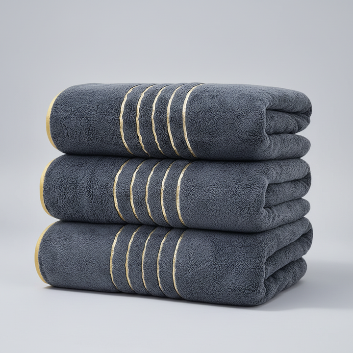 Close-up of soft, absorbent LuxuryWrap microfiber bath towel pile, perfect for home textiles