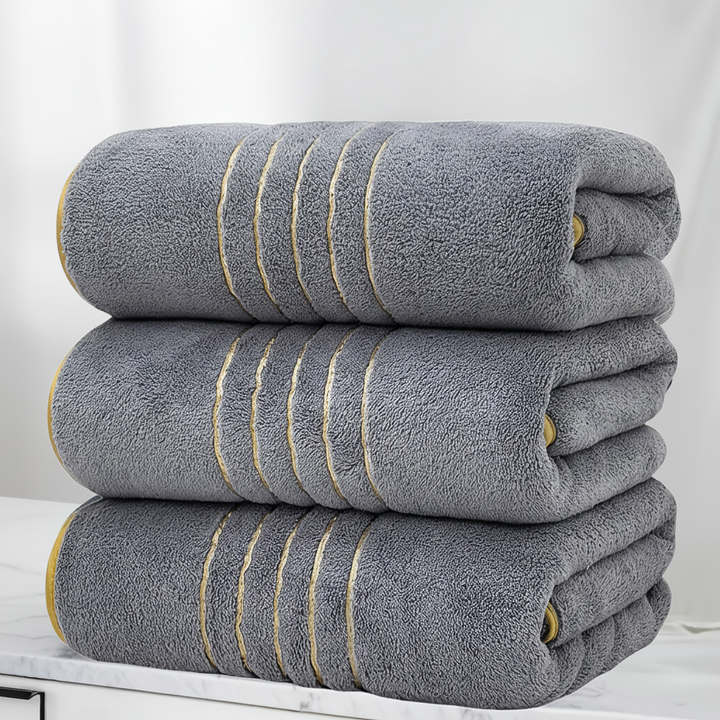 Folded LuxuryWrap microfiber bath towel set with striped pattern, a luxury bathroom essential