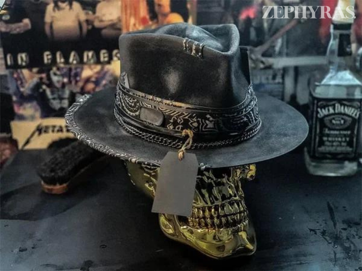 Close-up of a men's unique handmade felt hat showcasing an intricate raven skull design.