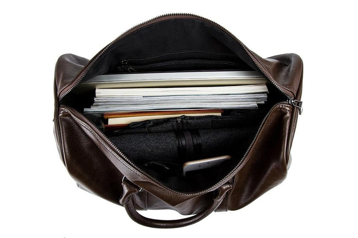 Two men's leather travel duffel bags, one black and one brown, side-by-side, showcasing color options