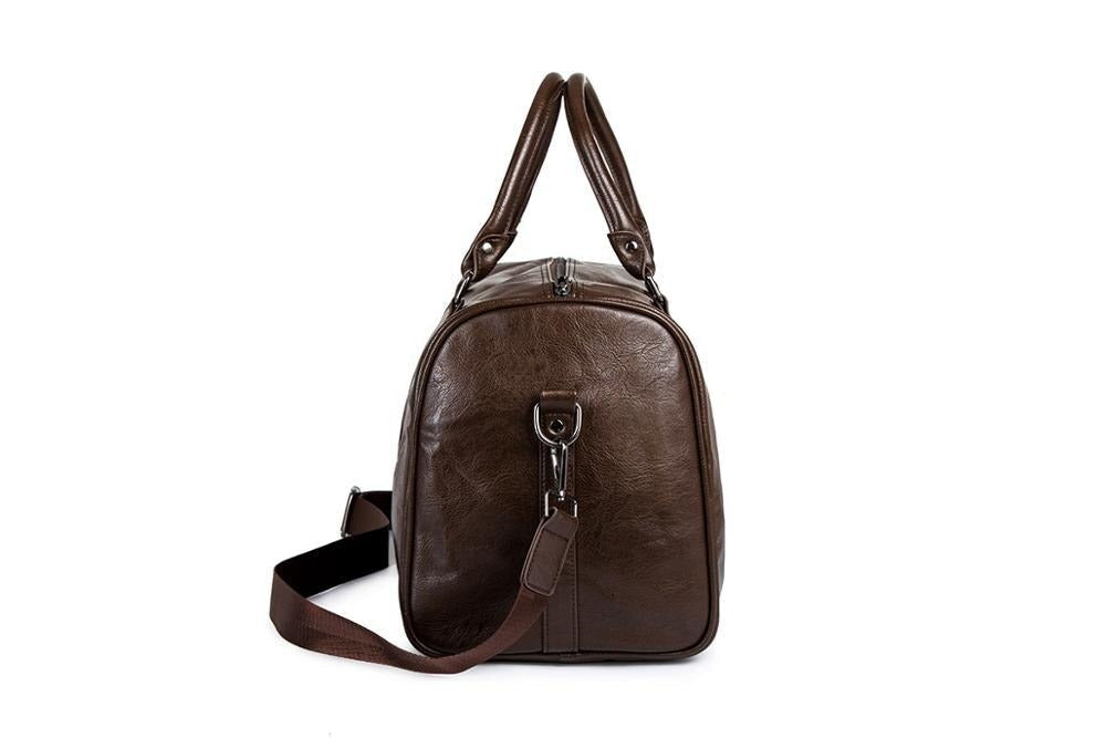 Men's black leather weekender bag standing upright, displaying its classic design and robust construction