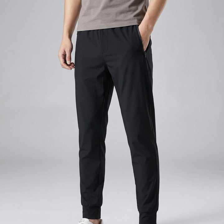 Men's quick-dry sports pants, black, with an elastic waist & tapered leg; great for fitness and casual wear.