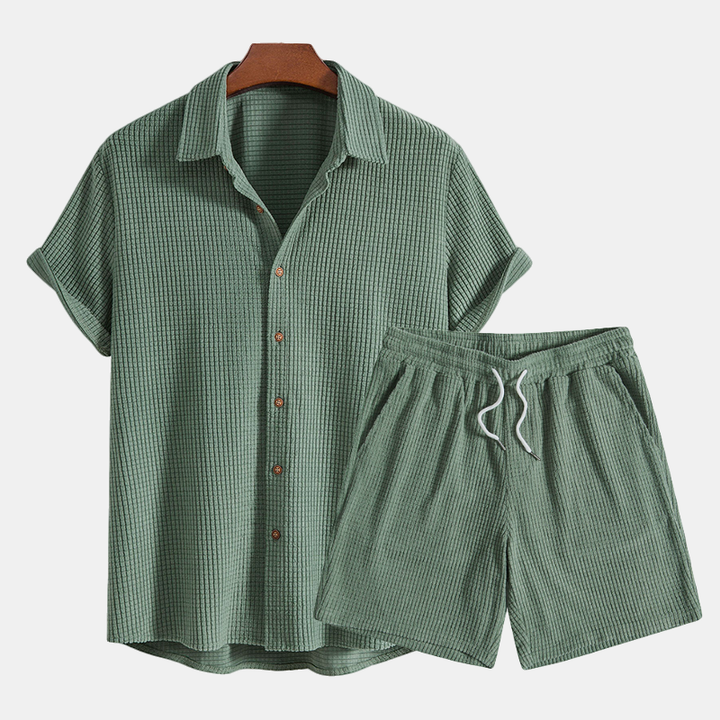 Casual men's matching waffle knit pajama set, great for warm weather comfort & relaxation.