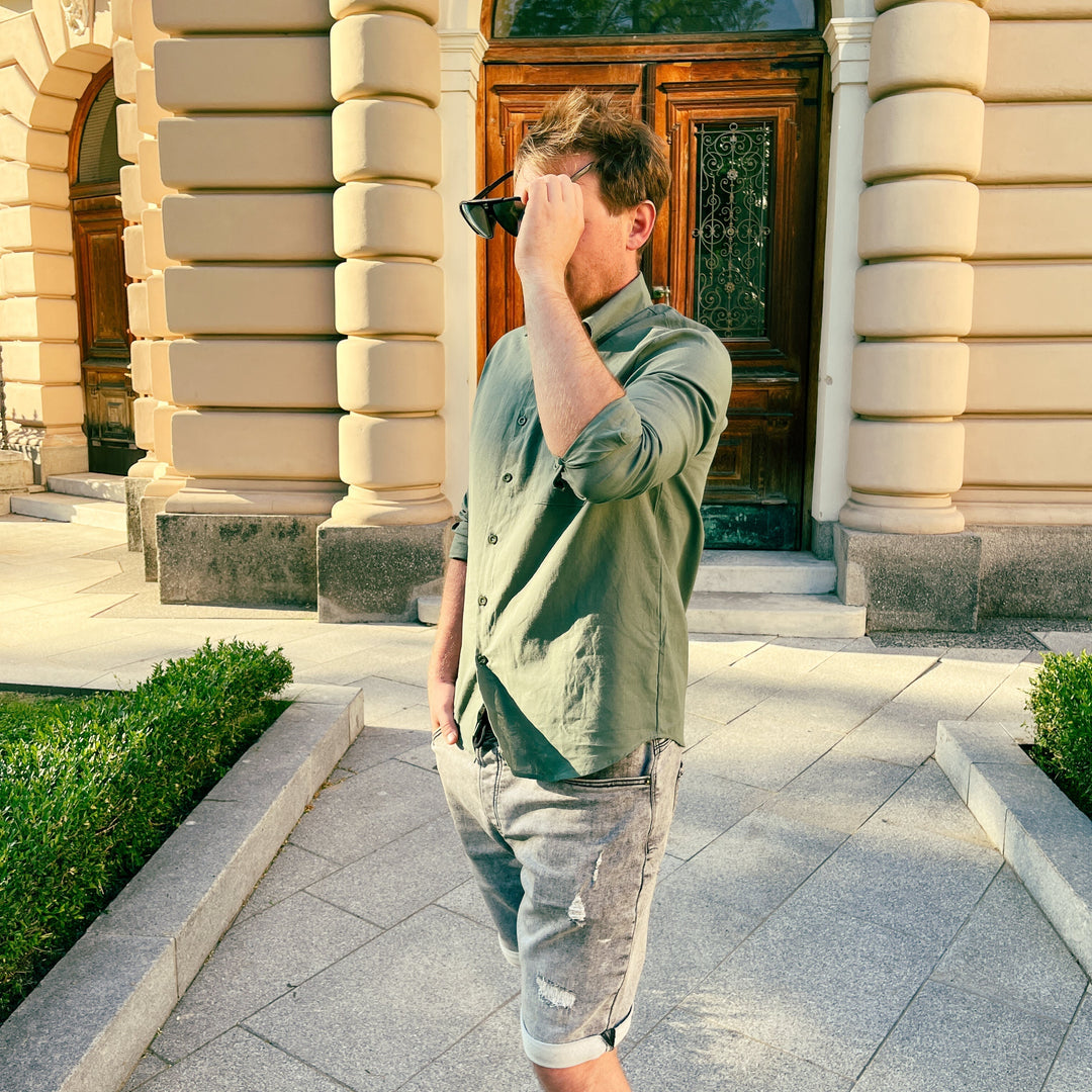 Folded men's breezy cotton shirt, ready for vacation or everyday summer style; lightweight & casual.