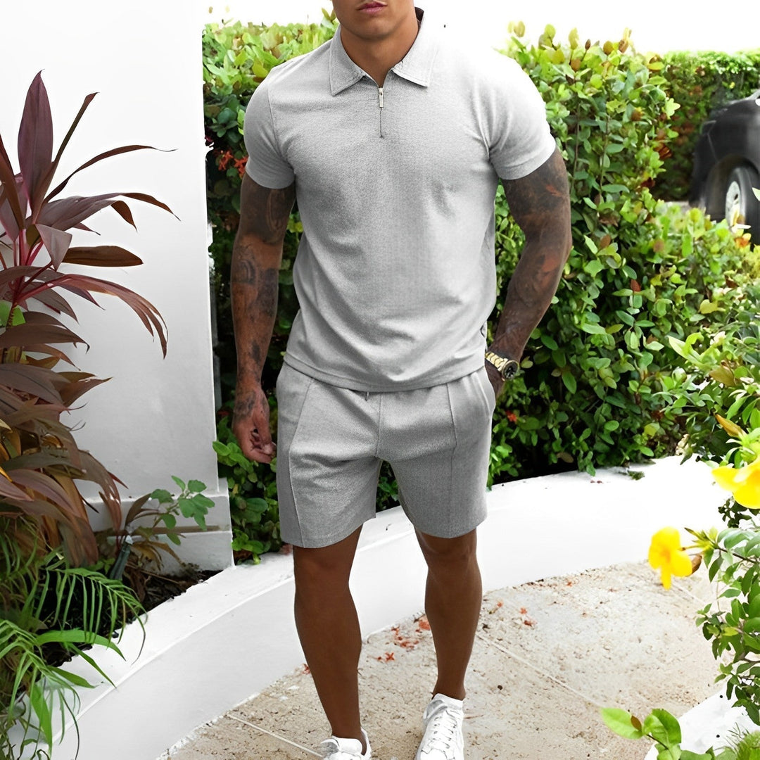 Men's casual summer polo shirt and shorts set in blue, breathable fabric, ideal for vacation loungewear.