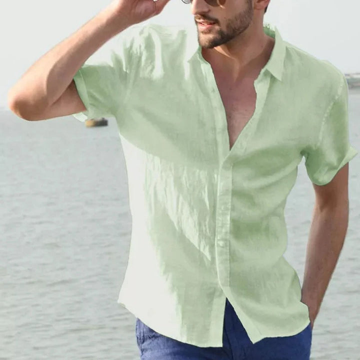 Man wearing a classic linen short sleeve shirt, ideal for summer casual style & warm weather comfort.