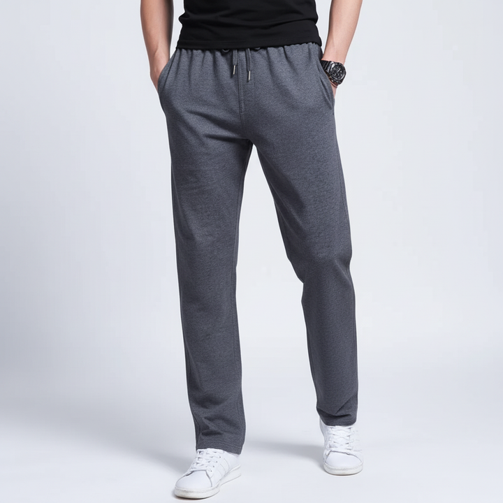Dark blue men's athletic track pants with cuffed ankles, combining comfort and sporty fashion.