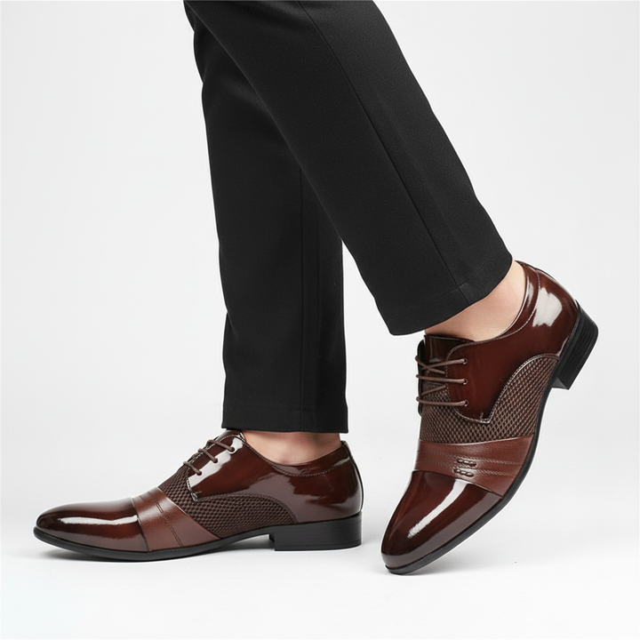 Close-up of men's black PU leather dress shoes, highlighting the pointed toe and lace-up detail