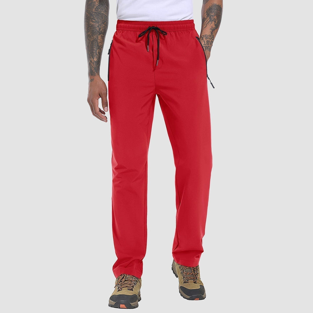 Man wearing FlexiTrek quick-dry stretch hiking trousers, confidently navigating a challenging trail.