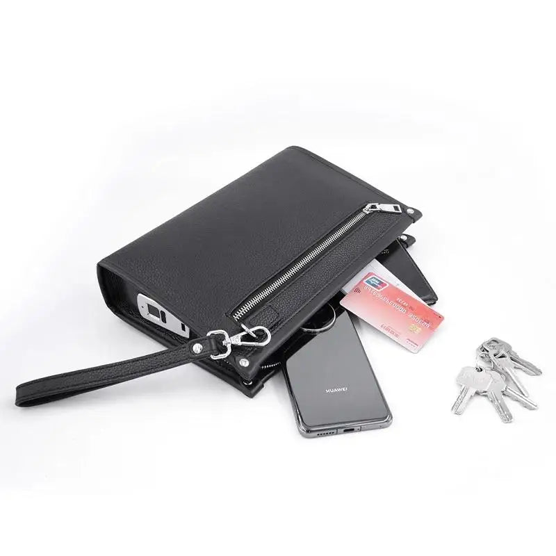 Hand holding a men's genuine leather business clutch, showcasing the compact executive design