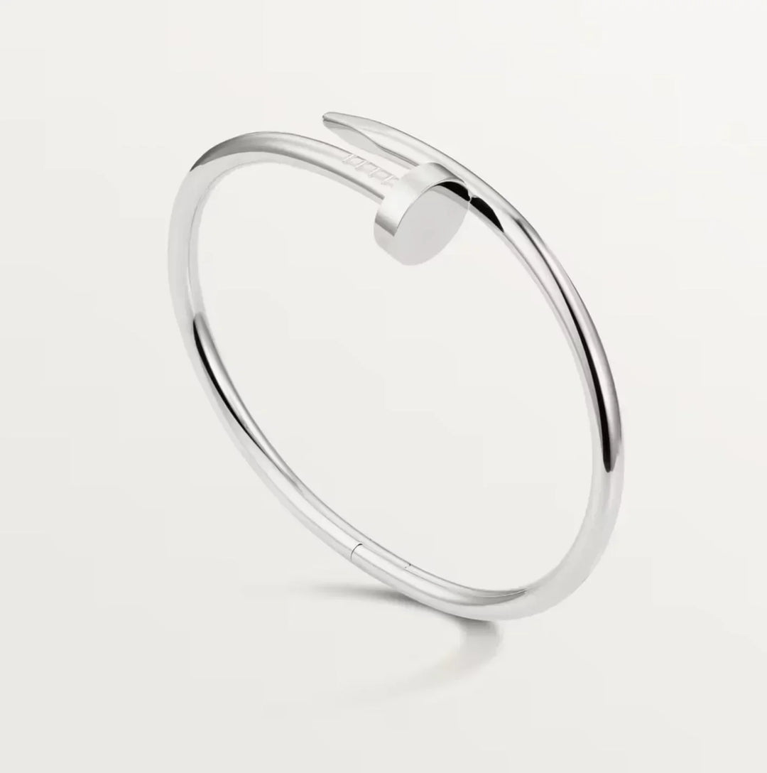 Men's industrial silver spike cuff bracelet; a bold, polished silver jewelry accessory for men's fashion.