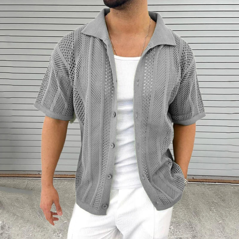 Stylish man wearing a blue knit short sleeve shirt with a classic collar for a relaxed summer look