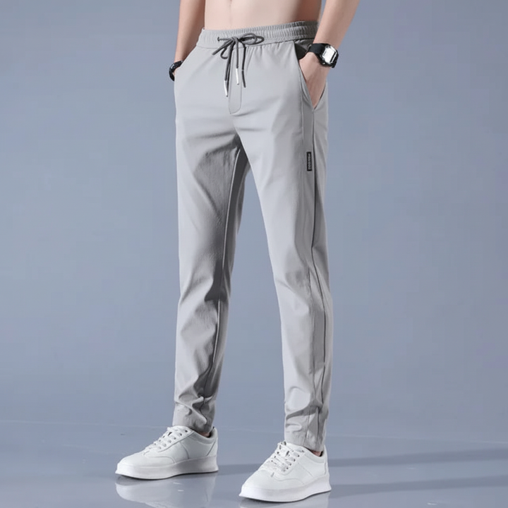 Pair of lightweight men's joggers folded, emphasizing their quick-dry material and compact design