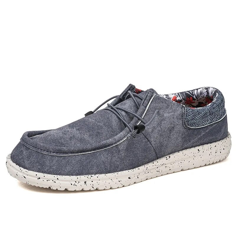 Close-up of men's lightweight summer slip-on loafers, showcasing breathable fabric & comfortable sole for casual wear.