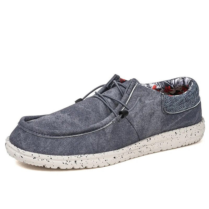Close-up of men's lightweight summer slip-on loafers, showcasing breathable fabric & comfortable sole for casual wear.