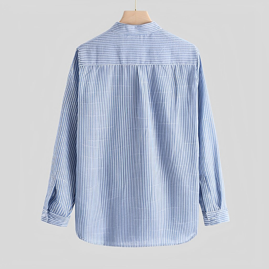 Close-up of a modern cut men's button-up shirt, showing cotton blend fabric