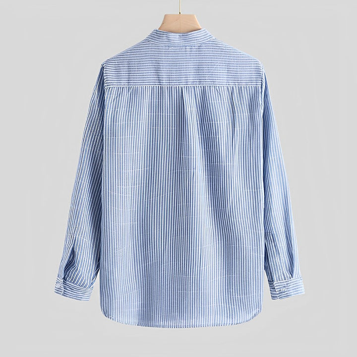 Close-up of a modern cut men's button-up shirt, showing cotton blend fabric