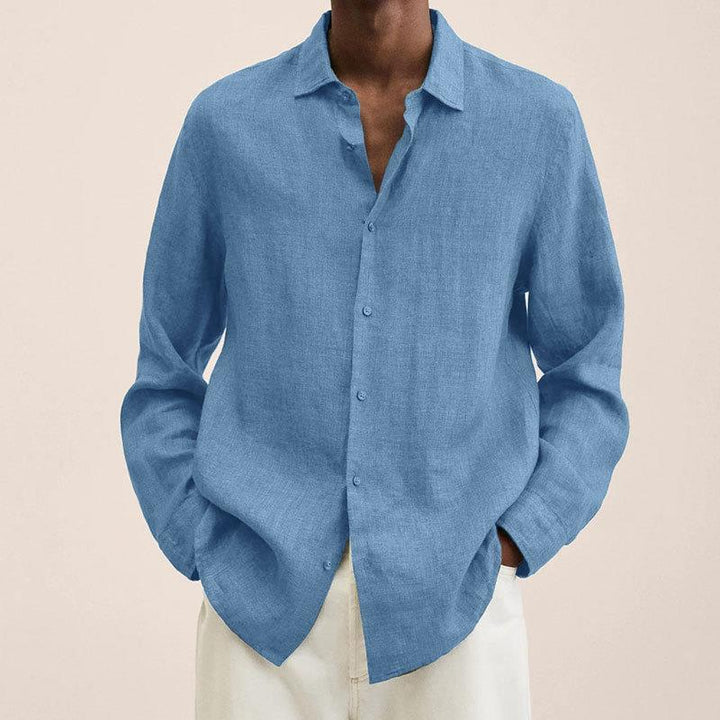 Man wearing a relaxed fit long sleeve linen cotton shirt in a neutral color, showcasing summer fashion.
