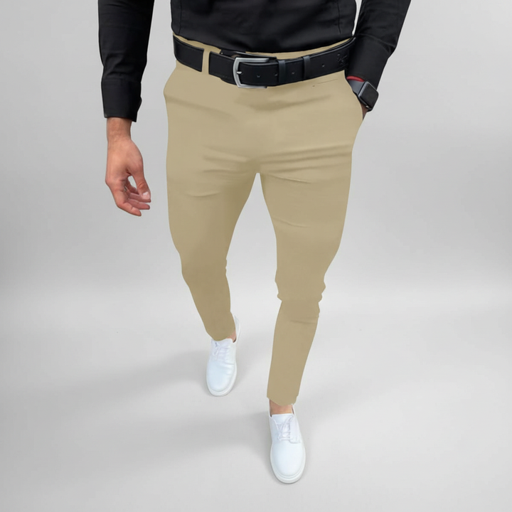 Detail shot of the button and zipper closure on men's comfort stretch slim fit trousers.