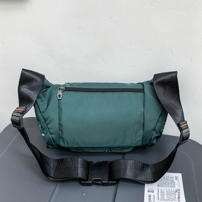 Men's black water-resistant crossbody bag, a durable nylon everyday carry and adventure essential.