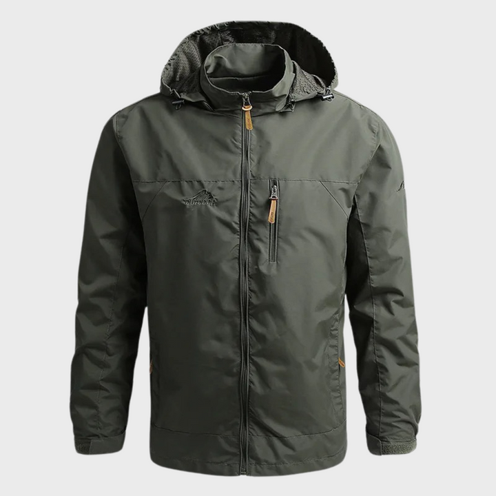 Man wearing a sleek ElementShield waterproof jacket, ready for diverse weather. Ideal men's rain jacket & windbreaker.