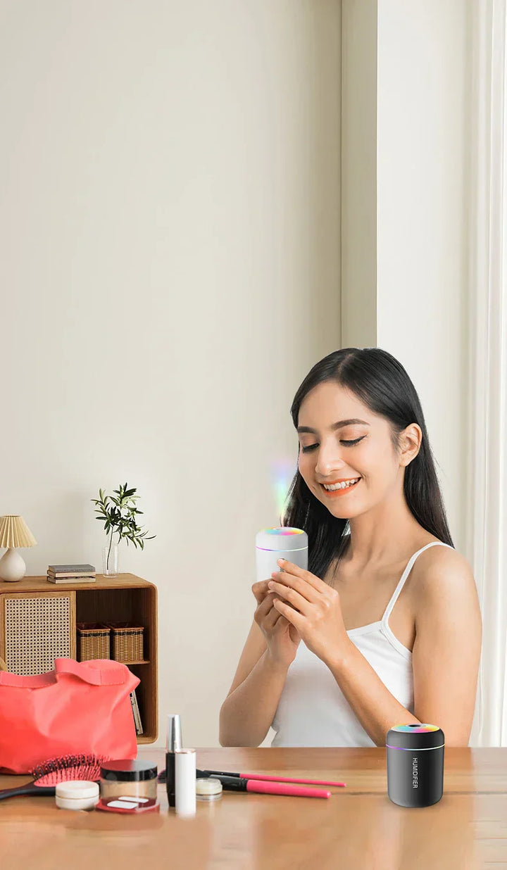 Lifestyle image of mini white humidifier & diffuser in use, discreet & effective, USB powered