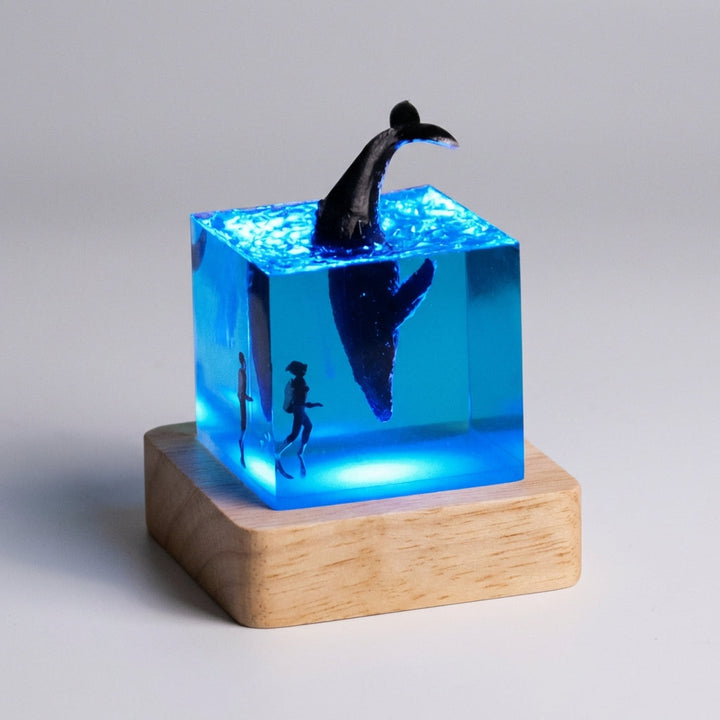 Modern table lamp, abstract landscape resin art, soft LED illumination for calm home decor, wooden base.