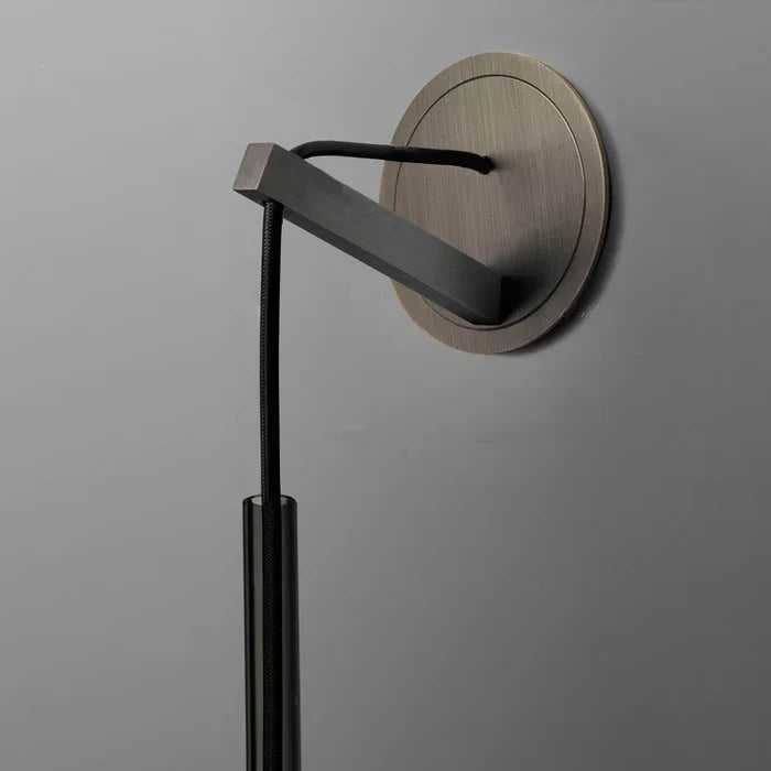 Close-up of minimalist smoked glass wall light, showcasing the conical design and modern aesthetic