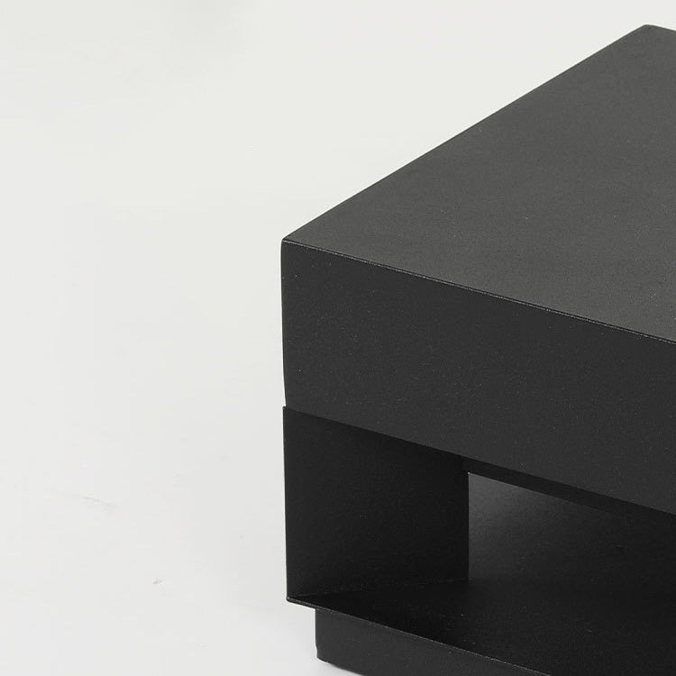 Weatherproof minimalist square outdoor lamp by LumaBloc illuminating a garden path at night
