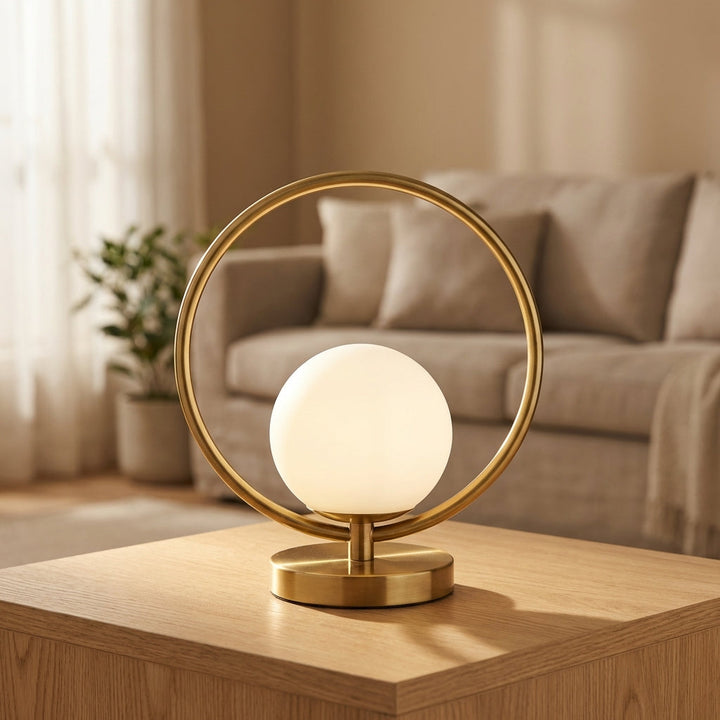 Modern dimmable LED ring orb table lamp casting a soft, warm glow, ideal for bedroom or desktop accent lighting.