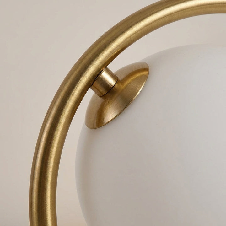 Elegant LED orb table lamp by Orbella with dimmable light, enhancing modern bedroom decor with a soft glow.