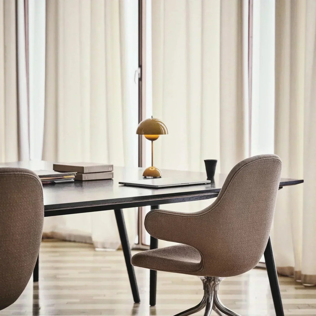 Contemporary dimmable LED table lamp. Rechargeable for versatile use in home decor or office lighting.