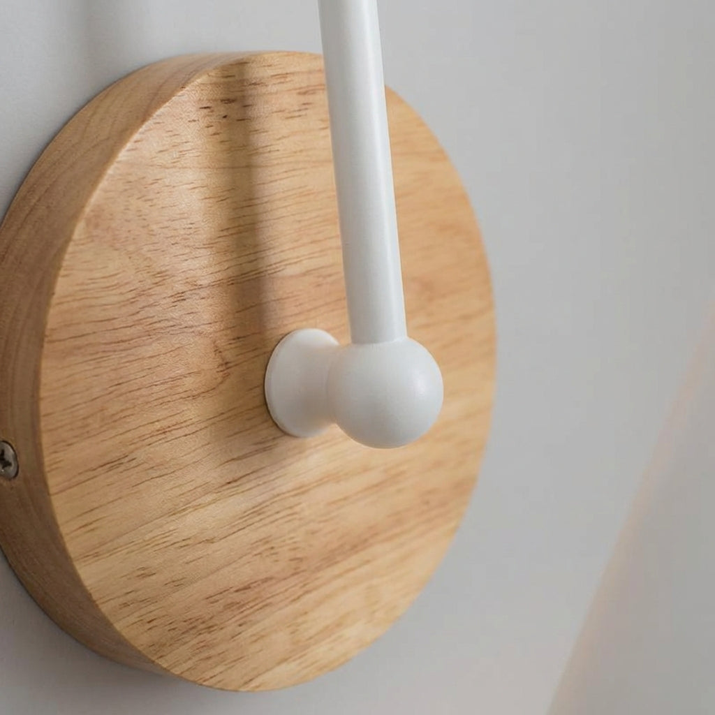 Stylish metal cone wall sconce with a warm wood detail, perfect for contemporary interiors.