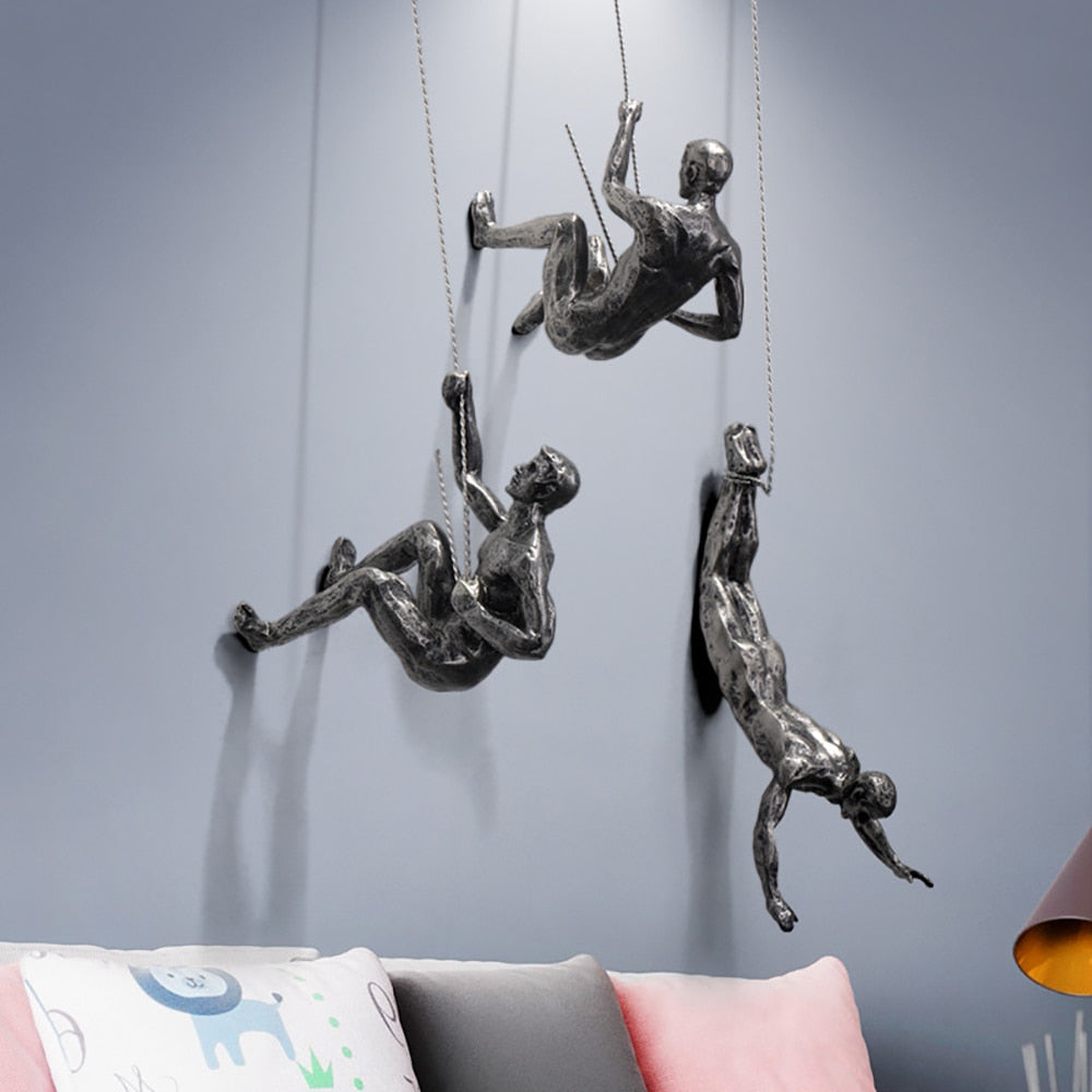 Stylish resin & metal climber wall sculpture, a unique and inspirational modern art piece for home decor.